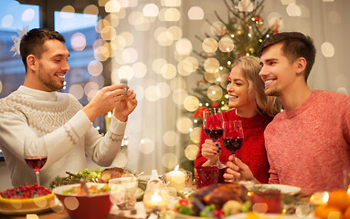 Image showing happy friends photographing at christmas dinner