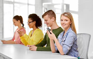 Image showing happy high school students with smartphones