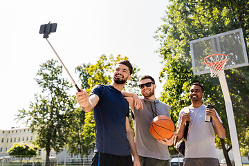 Image showing happy men taking selfie at basketball playground