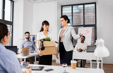 Image showing executive seeing off fired female office worker