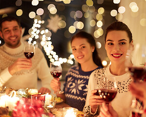 Image showing happy friends celebrating christmas at home