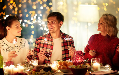 Image showing happy friends celebrating christmas at home feast