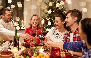 Image showing friends celebrating christmas and drinking wine