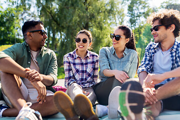 Image showing friends hanging out and talking outdoors in summer