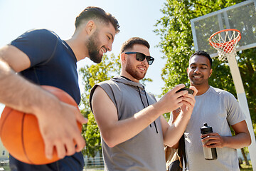 Image showing men with smartphone on basketball playground