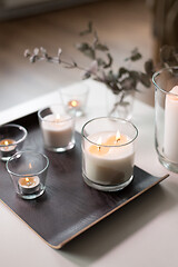 Image showing burning fragrance candles on table at cozy home