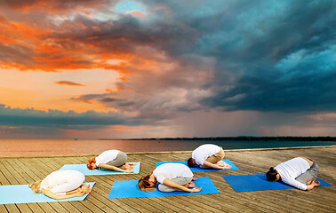 Image showing group of people making yoga exercises outdoors