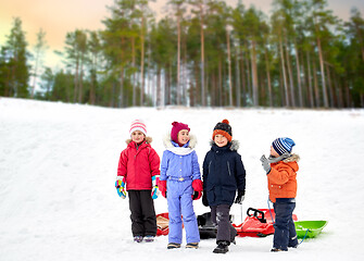 Image showing happy little kids with sleds in winter