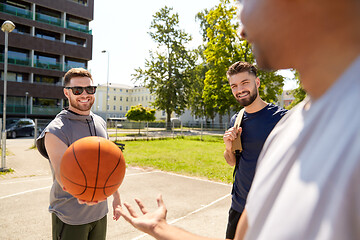 Image showing group of male friends playing street basketball