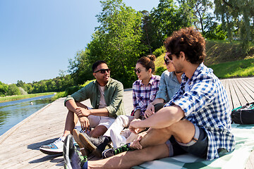 Image showing friends hanging out and talking outdoors in summer