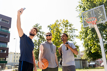 Image showing happy men taking selfie at basketball playground