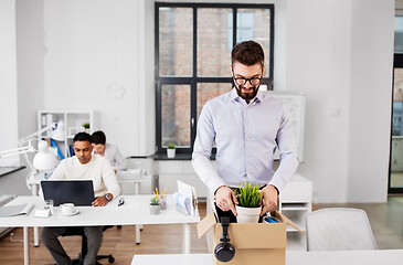 Image showing happy male office worker with personal stuff