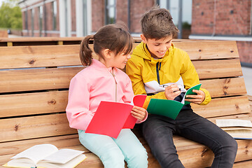 Image showing school children with notebooks sitting on bench