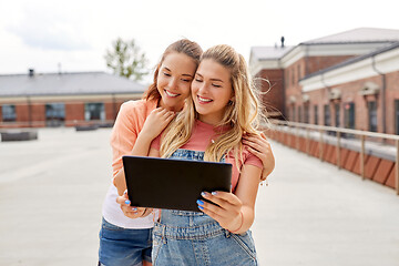 Image showing teenage girls with tablet computer on roof top