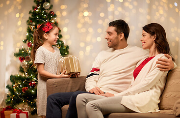 Image showing happy family with christmas present at home