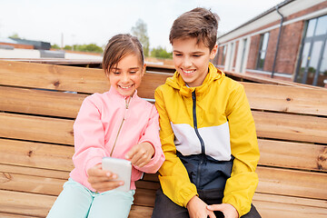 Image showing children with smartphones sitting on street bench