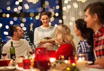 Image showing happy friends having christmas dinner at home