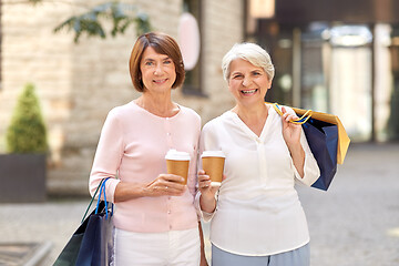 Image showing senior women with shopping bags and coffee in city