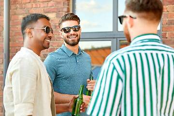 Image showing happy male friends drinking beer in summer city