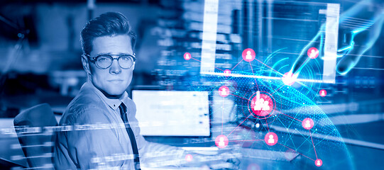 Image showing man working on computer in dark office