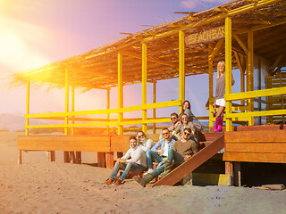 Image showing Group of friends having fun on autumn day at beach