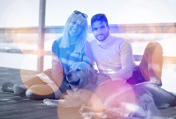 Image showing Couple with dog enjoying time on beach