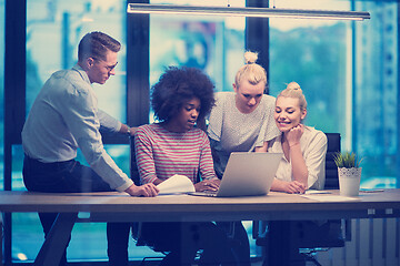 Image showing Multiethnic startup business team in night office