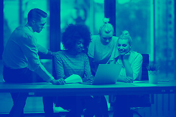 Image showing Multiethnic startup business team in night office