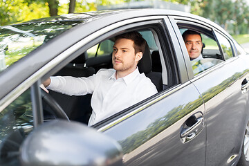 Image showing male driver driving car with passenger