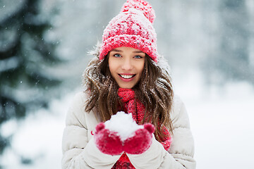 Image showing portrait of young woman with snow in winter park