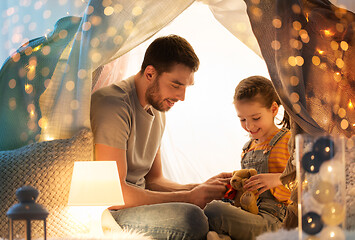 Image showing happy family playing with toy in kids tent at home