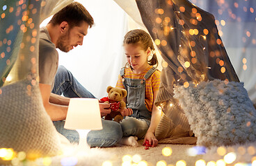 Image showing happy family playing with toy in kids tent at home