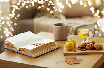 Image showing book, lemon, tea and cookies on table at home