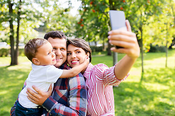 Image showing happy family taking selfie at summer park