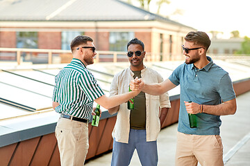 Image showing happy male friends drinking beer at rooftop party