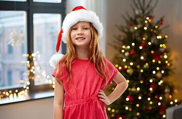 Image showing happy red haired girl in santa helper hat at home