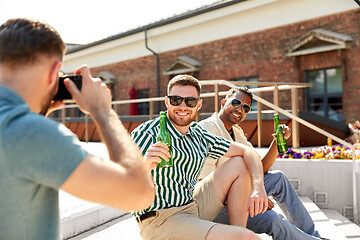 Image showing man photographing friends drinking beer on street