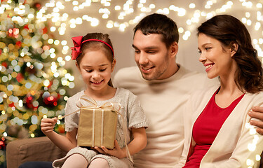 Image showing happy family with christmas present at home