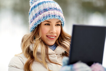 Image showing woman with tablet computer outdoors in winter