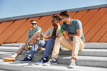Image showing happy male friends drinking beer on street