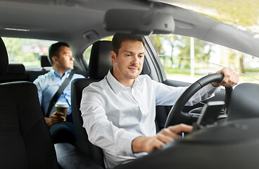 Image showing male driver driving car with passenger