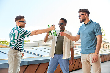 Image showing happy male friends drinking beer at rooftop party