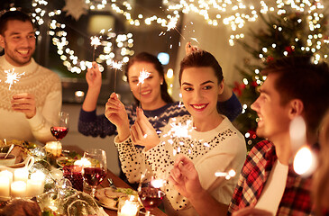 Image showing happy friends celebrating christmas at home feast