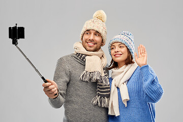 Image showing happy couple in winter clothes taking selfie