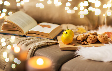 Image showing lemons, book, almond and oatmeal cookies on sofa