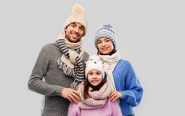 Image showing happy family in winter clothes on grey background