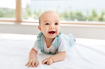 Image showing sweet baby girl lying on white blanket