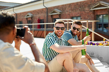 Image showing man photographing friends drinking beer on street