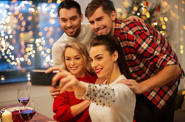 Image showing friends taking selfie at christmas dinner