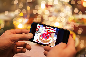 Image showing hands photographing food at christmas dinner